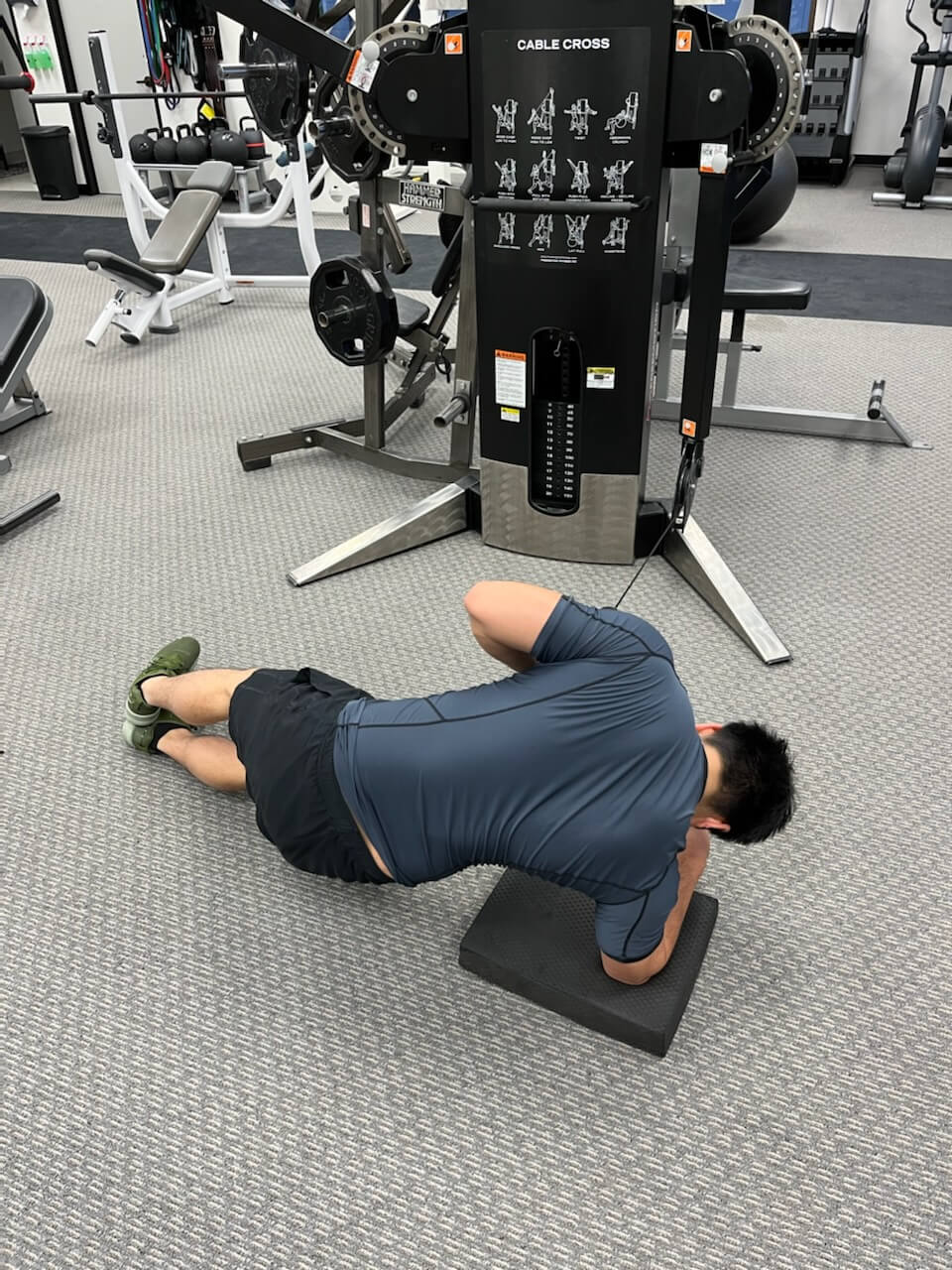 Man doing a side plank cable row.
